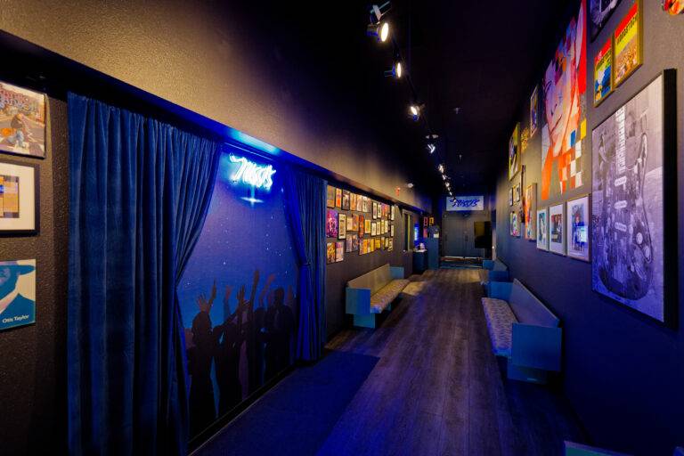 Hallway with blue curtains and framed artwork at Nissi’s