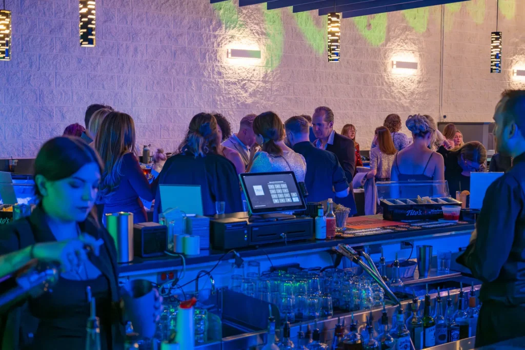 Guests gathering near Nissi’s bar during an event