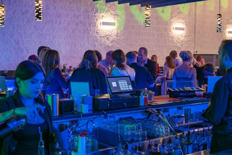 Guests gathering near Nissi’s bar during an event