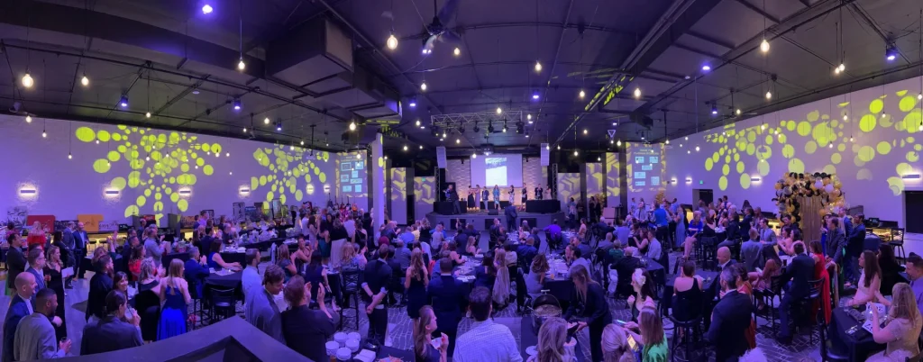 Guests gathered at tables under patterned lighting at Nissi’s
