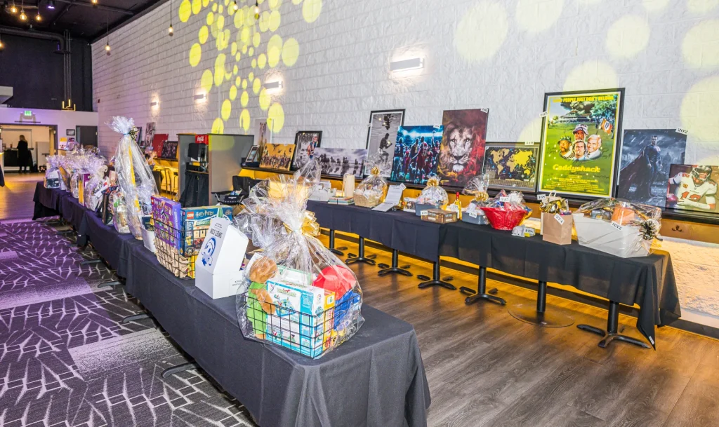 Silent auction items displayed on tables in Nissi’s event room